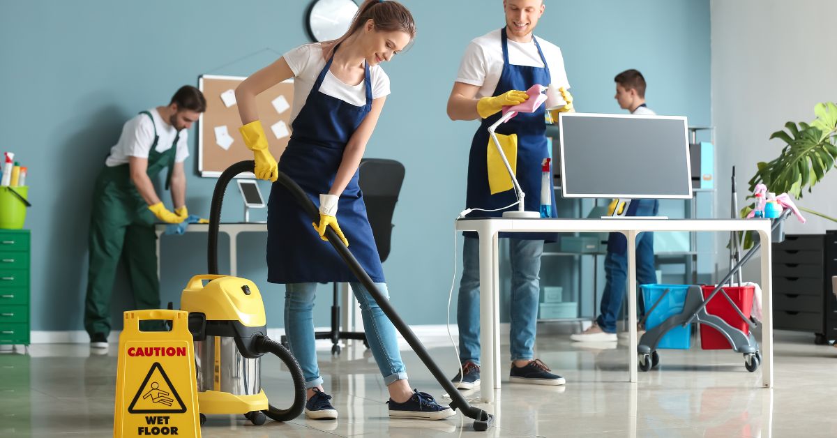 Arelli Cleaning crew performing routine office cleaning tasks like vacuuming and disinfecting surfaces in a Toronto workplace