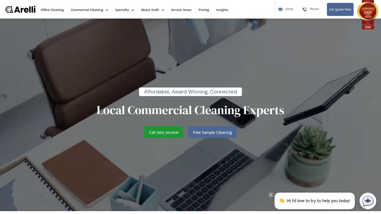 A professional cleaner from Arelli Cleaning is shown wiping down a modern office desk with a microfibre cloth, demonstrating attention to detail.